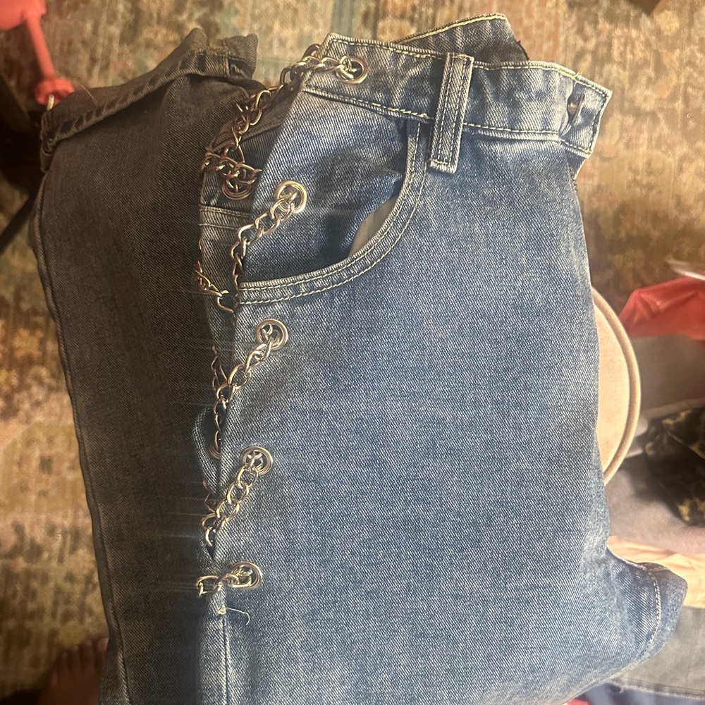 PrettyLittleThing denim blue jeans with silver Chain Accents.